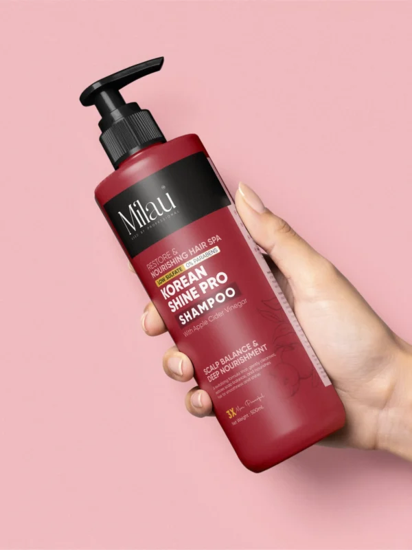 hand holding korean shampoo bottle with shiny smooth hair background