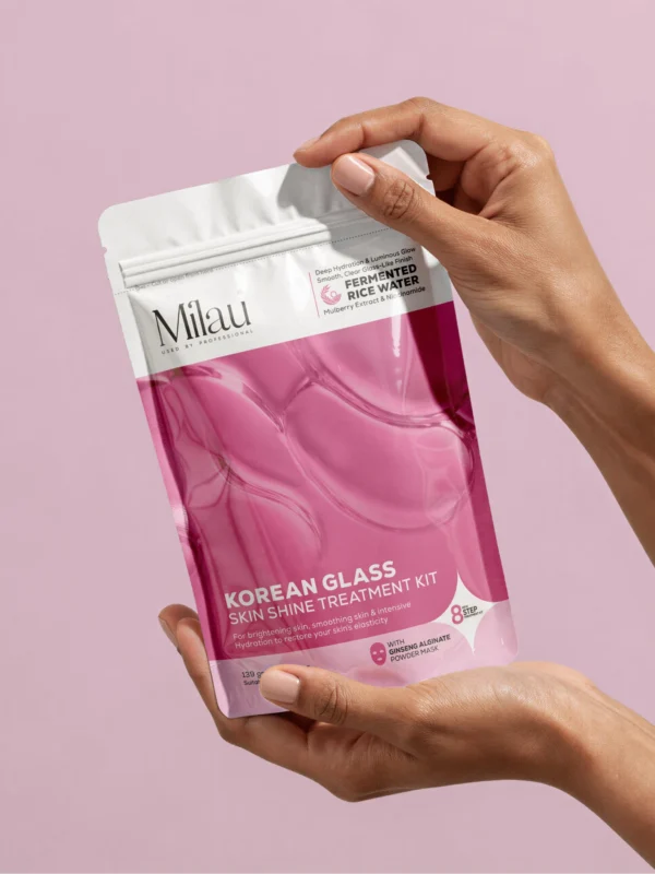 Hand holding Korean glass skin facial kit pouch for hydration and brightening skincare routine